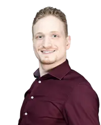 Profilbild: Ole Reglitzki schaut freundlich in die Kamera. Das Bild ist rund eingerahmt, wobei der Kopf aus dem Rahmen ausbricht; dies wirkt offen und fügt sich gut ins moderne Layout der Seite ein.